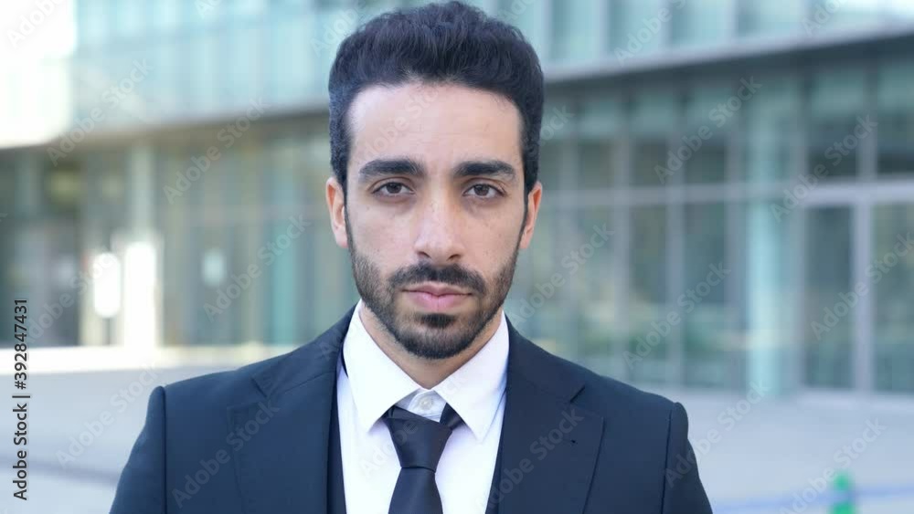 Smiling arabian businessman in the city. Slow motion. Smiling arabian businessman in the city. Slow motion.