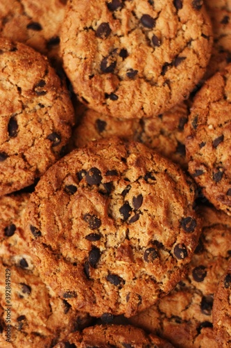 Delicious oatmeal cookies with chocolate on the table