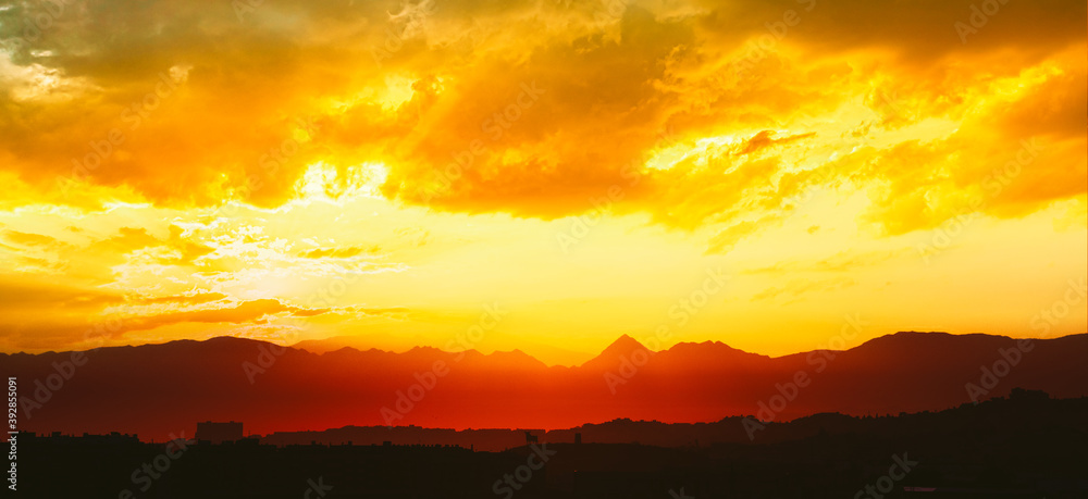 Spain, Andalusia. Amazing Sunset Sunrise With Sun Over Dark Mountain Ground. Bull Silhouette.