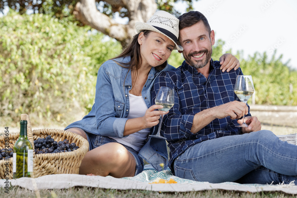 cute couple drinking wine on a picnic cute couple drinking wine on a picnic