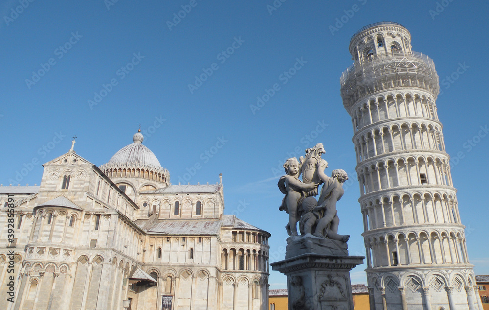 The Putti fountain in Piazza dei Miracoli in Pisa. On the right the Leaning Tower of Pisa and on the left the Cathedral of Pisa.    