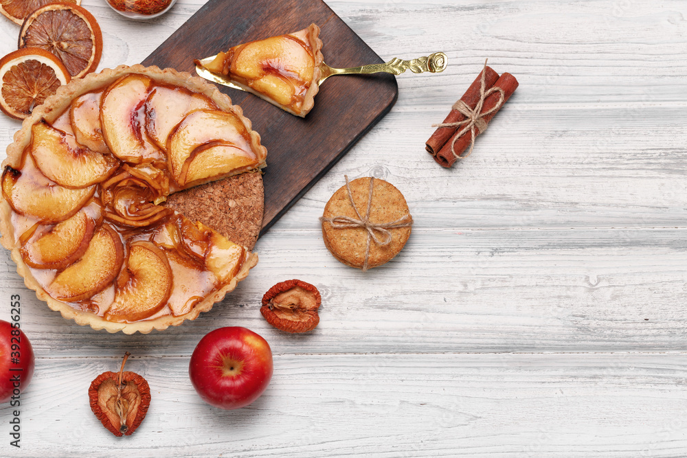 Fototapeta premium Top view of an apple pie on white wooden surface