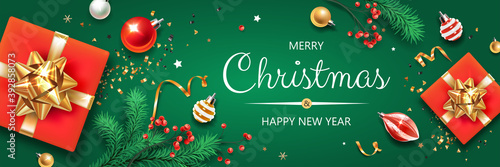 Horizontal banner with Christmas symbols and text. Christmas tree, gifts, balls, decoration and other festive elements on green background.