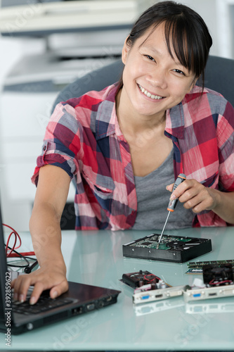 Wallpaper Mural female asian computer technician using multimeter Torontodigital.ca