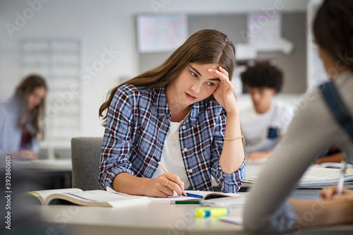 Stressed and worried girl durig exam at school photo
