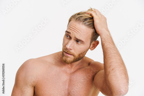 Handsome caucasian shirtless man posing and looking aside