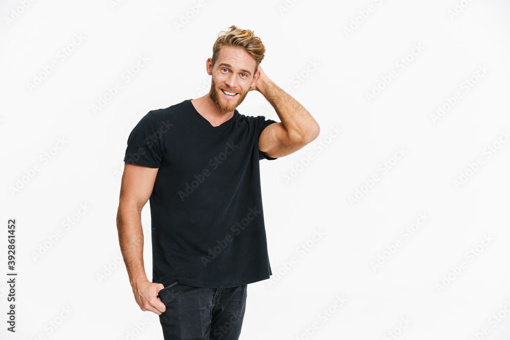 Fototapeta premium Pleased caucasian blonde man posing and smiling at camera