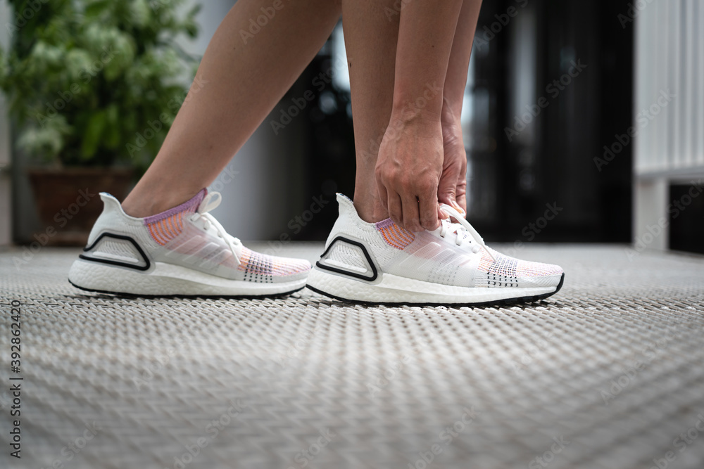 fish Undo Children Center Bangkok / Thailand - June 2020 : A sport girl is wearing adidas "Ultraboost"  running shoe in white color.