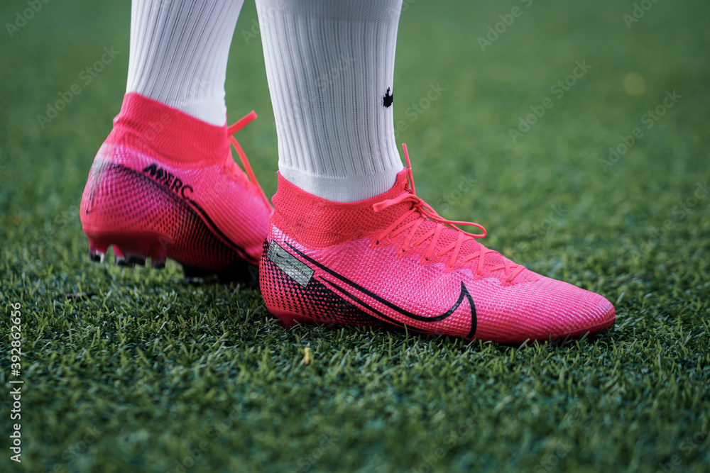 Bangkok / June 2020 : A person is wearing Nike "Mercurial Superfly VII"  football shoe in bright pink colorful, preparing for play football in local  artificial turf. Stock Photo | Adobe Stock