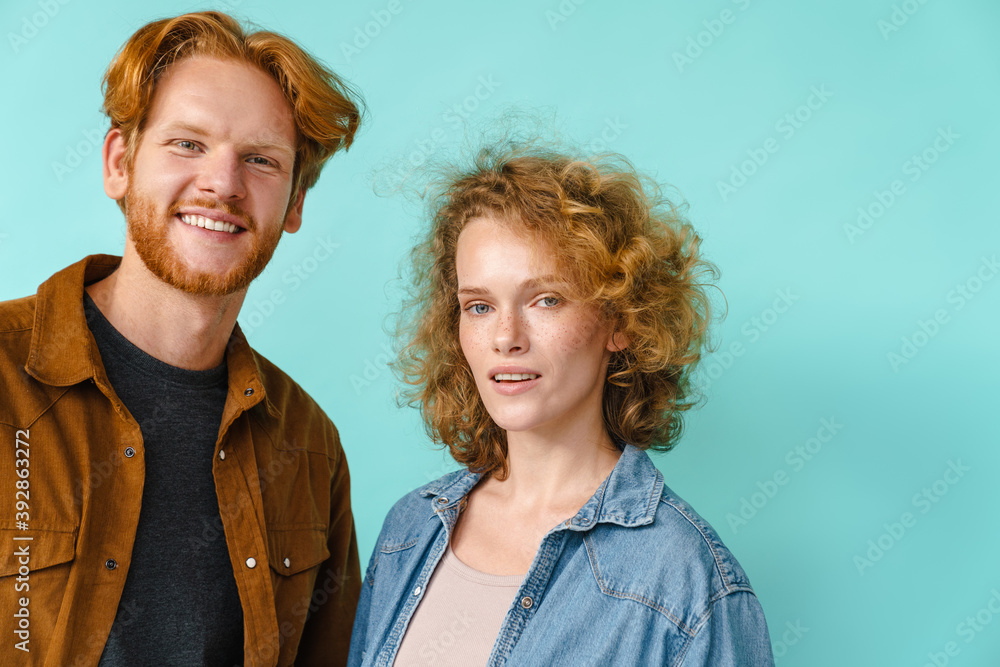 Young happy redhead couple smiling and looking at camera Young happy redhead couple smiling and looking at camera