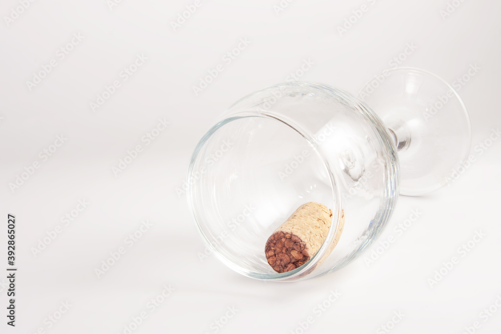 Wine cork in wine glass on white background