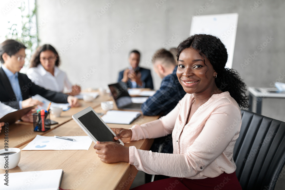 African American Businesswoman Using Tablet On Corporate Meeting In Office African American Businesswoman Using Tablet On Corporate Meeting In Office