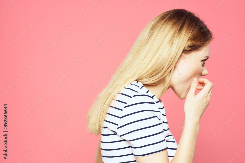 Blonde striped t-shirt emotion gesture hands displeased facial expression pink background Blonde striped t-shirt emotion gesture hands displeased facial expression pink background