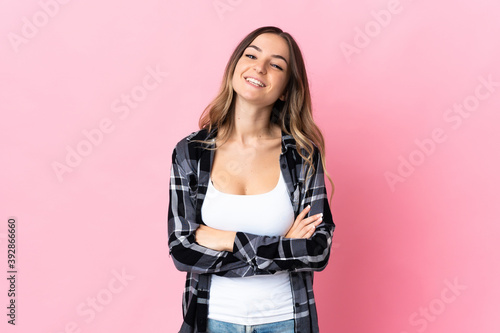 Young Romanian woman isolated on pink background keeping the arms crossed in frontal position