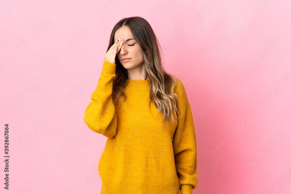 Young Romanian woman isolated on pink background with headache Young Romanian woman isolated on pink background with headache