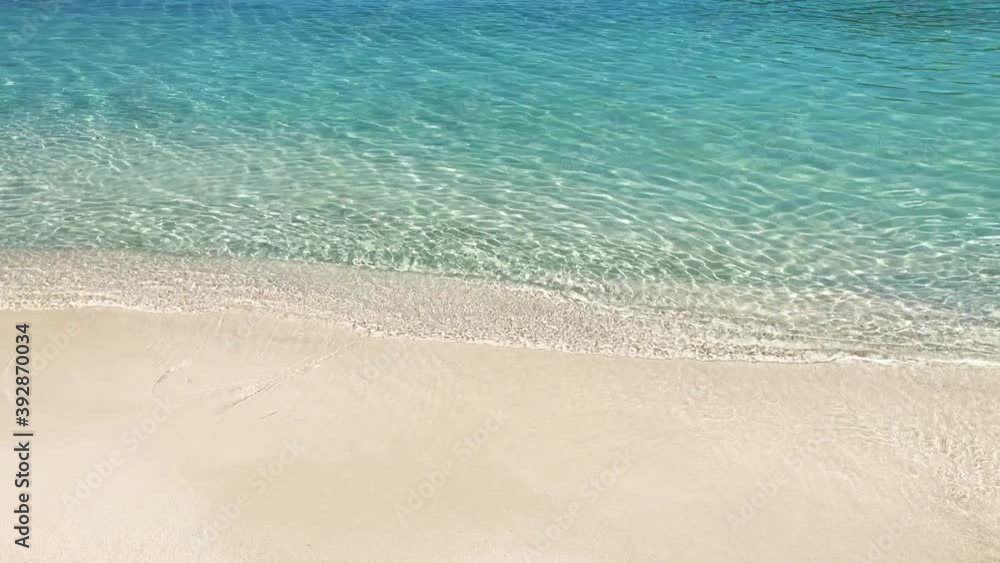 Crystal clear water and sand on beach of Ksamil in Albania, border between the Adriatic and Ionian seas Crystal clear water and sand on beach of Ksamil in Albania, border between the Adriatic and Ionian seas