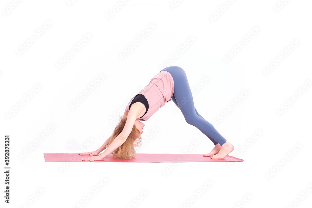 middle aged woman yoga asanas. instructor shows a pose from yoga isolated on a white background. woman practicing yoga concept natural balance between body and mental development. middle aged woman yoga asanas. instructor shows a pose from yoga isolated on a white background. woman practicing yoga concept natural balance between body and mental development.