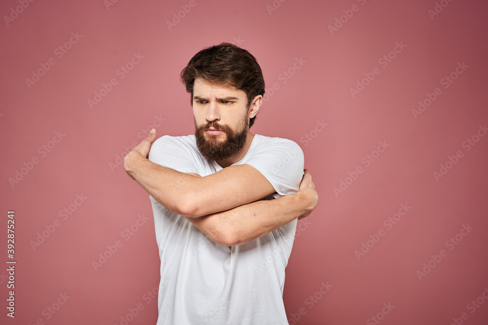 Man in white t-shirt emotions lifestyle facial expression cropped view pink background. Man in white t-shirt emotions lifestyle facial expression cropped view pink background.