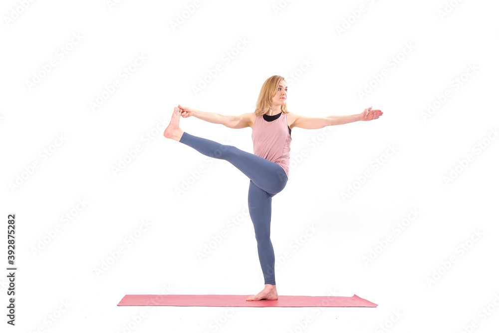 middle aged woman yoga asanas. instructor shows a pose from yoga isolated on a white background. woman practicing yoga concept natural balance between body and mental development. middle aged woman yoga asanas. instructor shows a pose from yoga isolated on a white background. woman practicing yoga concept natural balance between body and mental development.