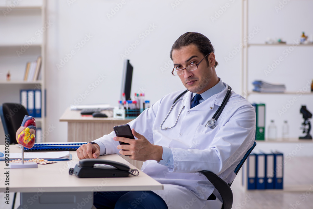 Young male doctor cardiologist working in the clinic Young male doctor cardiologist working in the clinic