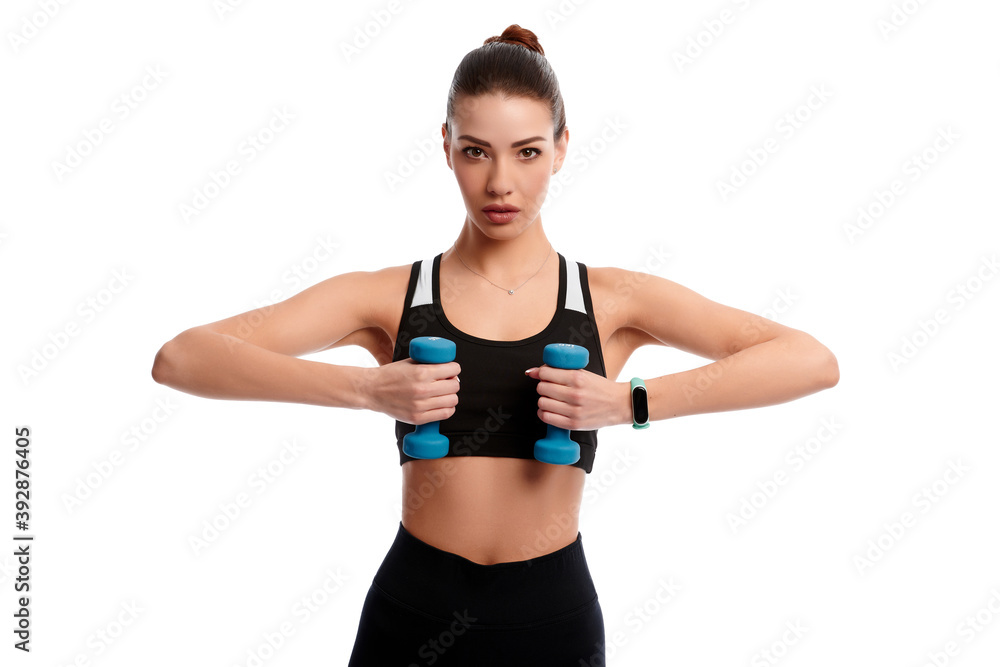 Attractive caucasian slim woman doing physical exercise using dumbbell isolated on white background Attractive caucasian slim woman doing physical exercise using dumbbell isolated on white background