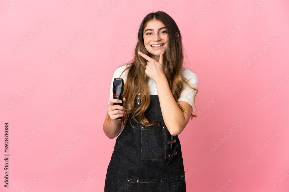 Young hairdresser woman isolated on pink background happy and smiling Young hairdresser woman isolated on pink background happy and smiling