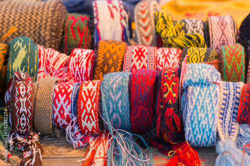 Braided woolen bracelets on the counter of the store
