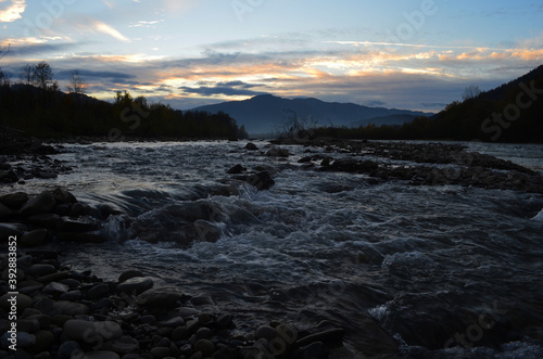 Wallpaper Mural Beautiful landscape with high mountains with illuminated peaks, stones in mountain lake, reflection, blue sky and yellow sunlight in sunrise. Torontodigital.ca