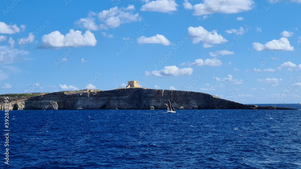 The small island of Comino sits between Malta and Gozo. Also seen is St. Mary's Tower also known as Comino Tower built in 1618. It was the 5th Wignacourt tower built by the Order of Saint John.