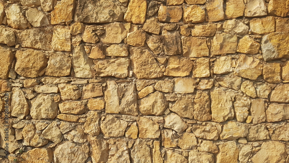 A Yellow Stone Wall for Backgrounds Backdrops or Copy Space
A Yellow Stone Wall for Backgrounds Backdrops or Copy Space