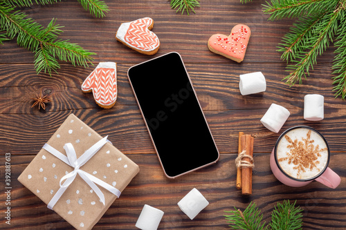 Canvas-taulu Christmas ambience with Mockup of smartphone and present on wooden background