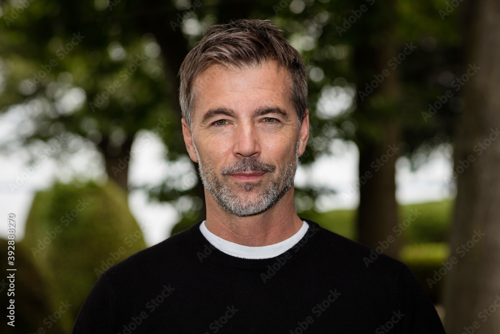 A serious handsome Mature Man looking At The Camera. Outside A serious handsome Mature Man looking At The Camera. Outside