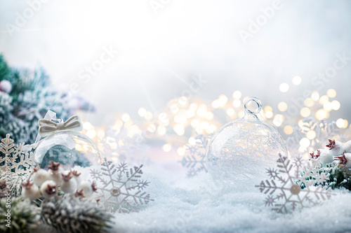 Christmas white decorations on snow with fir tree branches and christmas lights. Winter Decoration Background