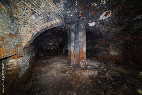 The basement of an old house with a domed vault and a supporting column. The picture was taken in Russia, in Orenburg