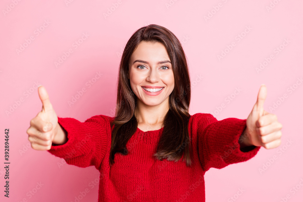 Photo of young cahrming girl raise two arms show thumb-up smile look camera wear red pullover isolated pink color background Photo of young cahrming girl raise two arms show thumb-up smile look camera wear red pullover isolated pink color background