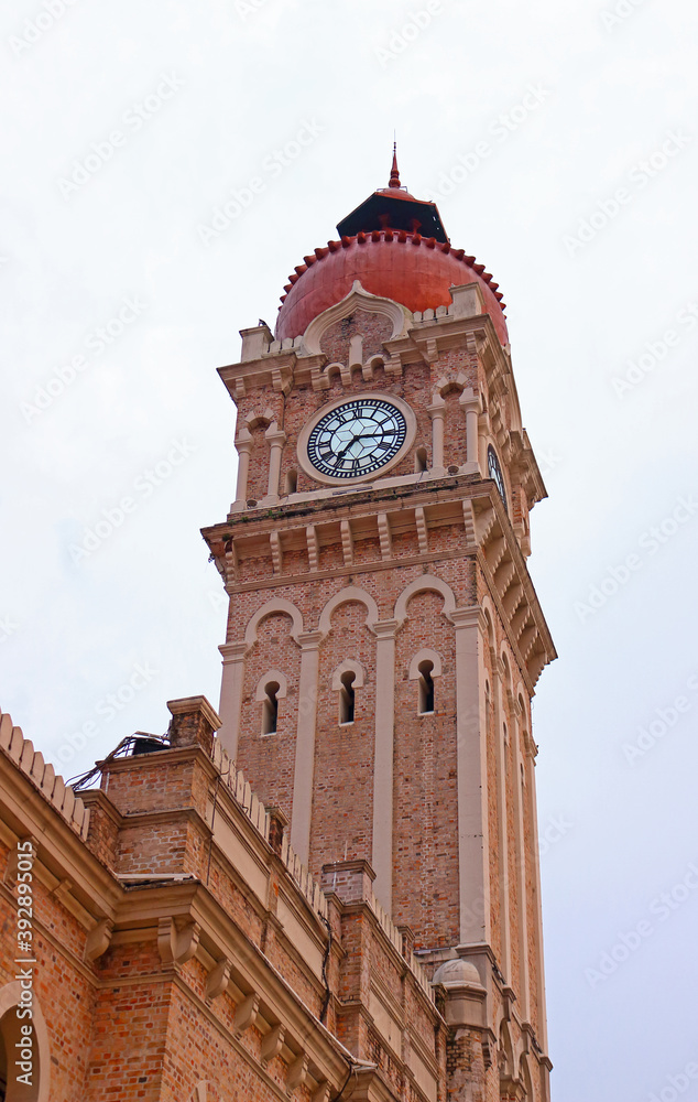Clock tower of Sultan Abdul Samad building at cloudy day in Kuala Lumpur, Malaysia. Year of completion of construction 1897.