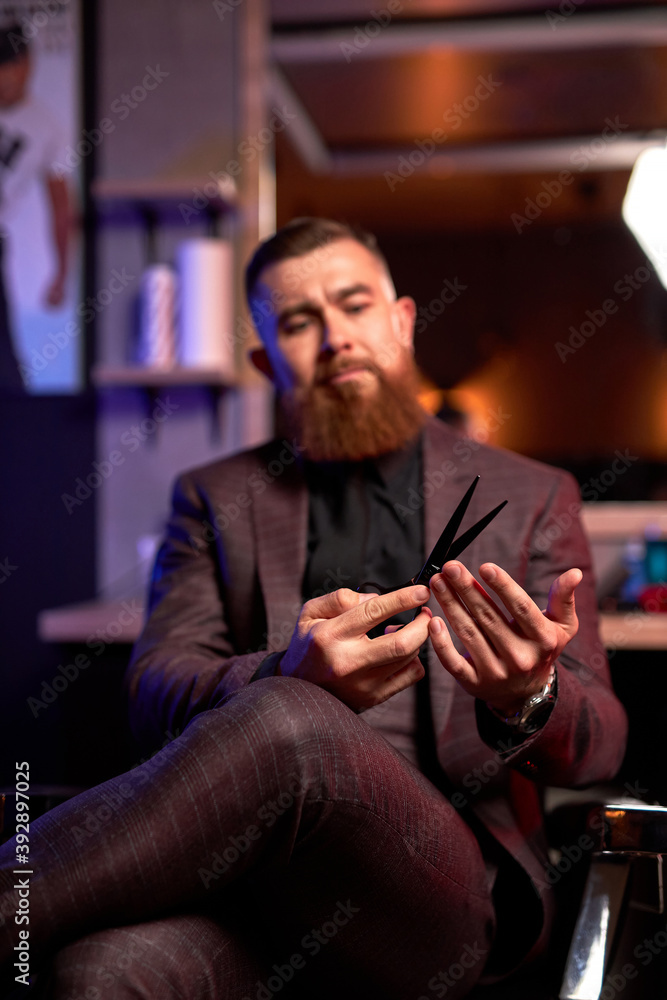close-up photo of scissors in hands of professional male barber, handsome guy in suit examining, checking scissors for future cutting hair of clients close-up photo of scissors in hands of professional male barber, handsome guy in suit examining, checking scissors for future cutting hair of clients