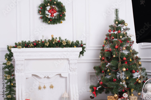 New Year's atmosphere in the studio. Decorations with a Christmas tree and a fireplace. © Haibullaev