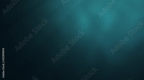 Sunlight beams shining from above coming through deep clear blue water causing beautiful water lighting reflection curtain.