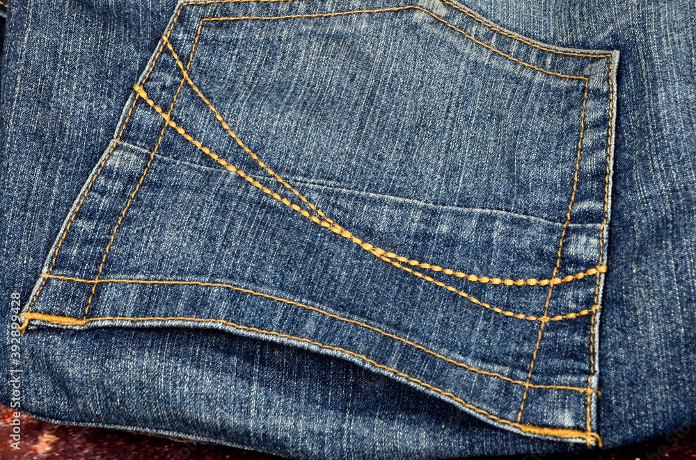 blue jeans pants fragments on an old rust background. Closeup of the detail of blue jeans blue jeans pants fragments on an old rust background. Closeup of the detail of blue jeans
