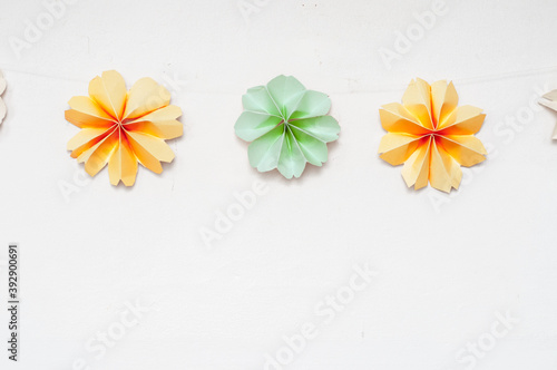 colorful paper decorations on white wall, paper flowers