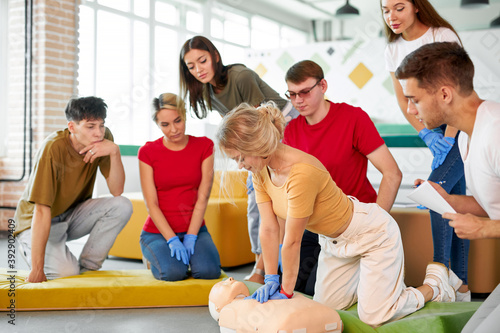 woman in first aid class exercising reanimation on dummy, indoors