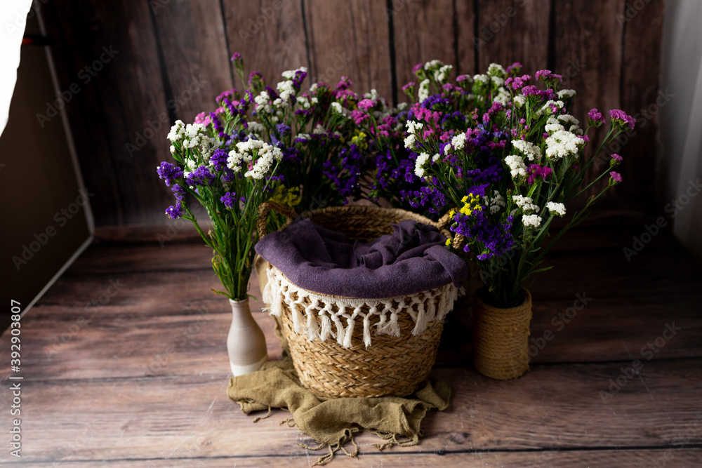 the basket is decorated with flowers. basket for a newborn photo shoot. background for a photo shoot the basket is decorated with flowers. basket for a newborn photo shoot. background for a photo shoot