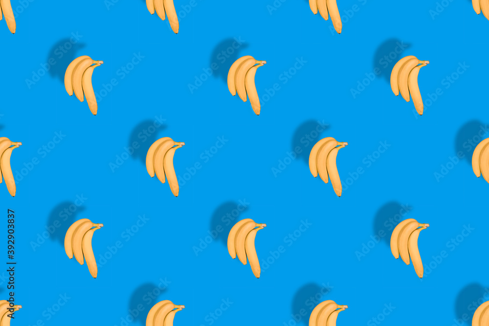 Seamless pattern of yellow bananas on a blue background.