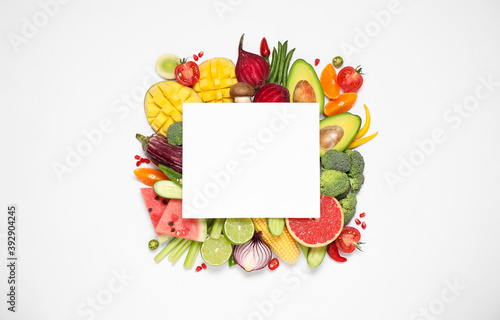 Composition with organic fresh vegetables, fruits and blank card on white background, top view. Space for text
