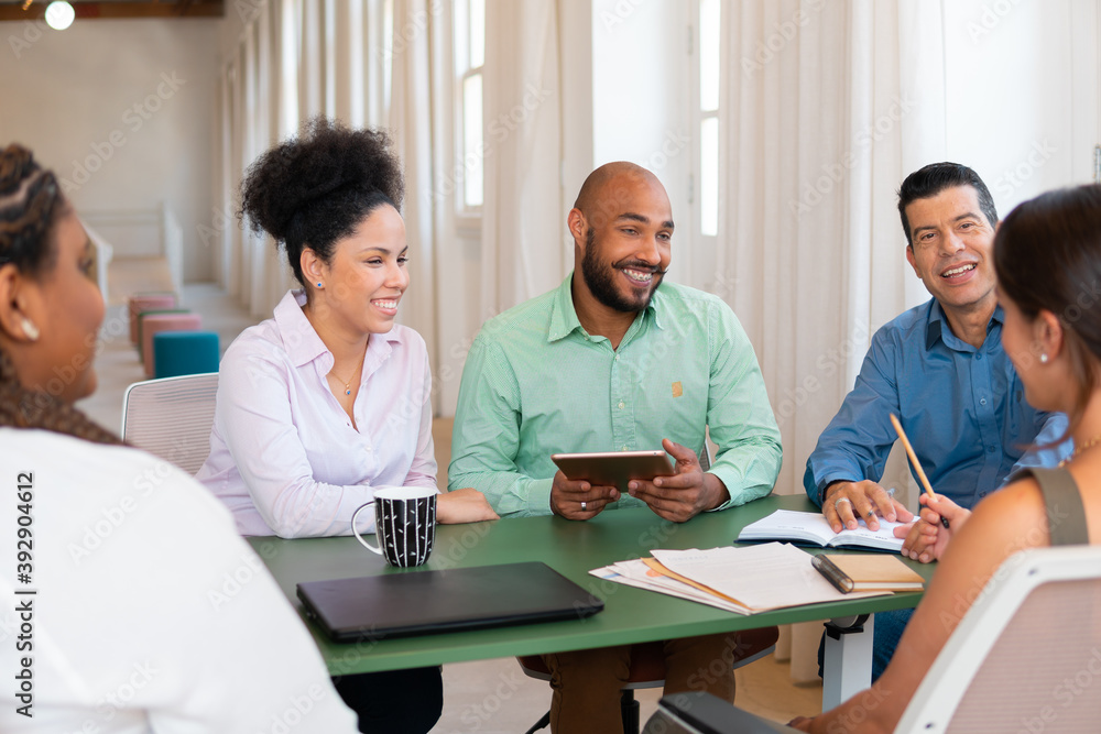 Brazilian diverse business workgroup working together at meeting in coworking office. Communication, cooperation, brainstorm concept.. Brazilian diverse business workgroup working together at meeting in coworking office. Communication, cooperation, brainstorm concept..