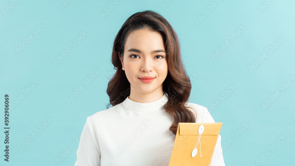 Portrait of a smiling young office worker holding folders of paperwork Portrait of a smiling young office worker holding folders of paperwork