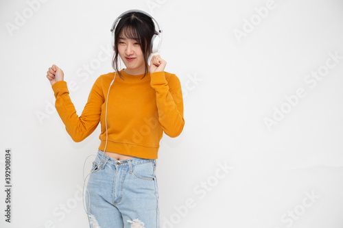 Photography Young Asian beauty woman listening music with headphones in playlist song applic