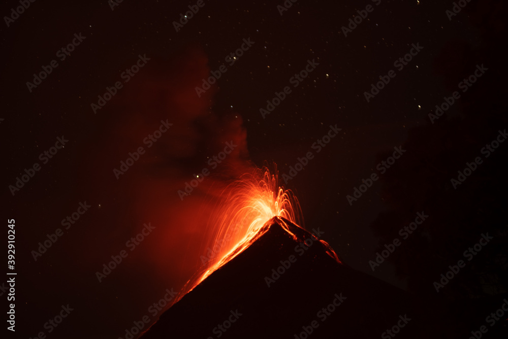 Lava spews into the night sky from Volcan de Fuego. Lava spews into the night sky from Volcan de Fuego.