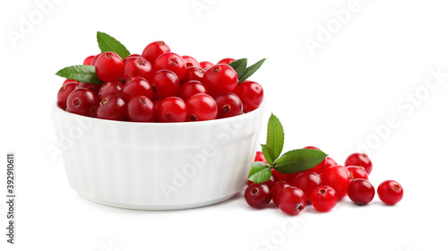 Fresh ripe cranberries with leaves on white background